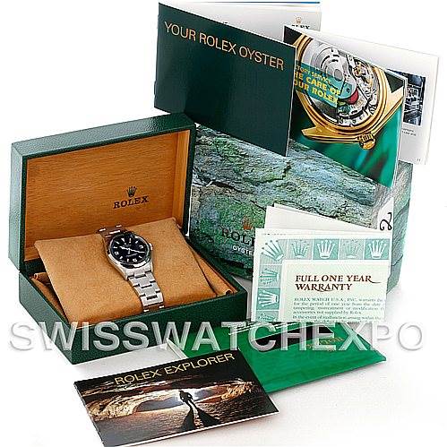 The image shows a Rolex Explorer 114270 Men's Stainless Steel Black Dial 114270 Men's Stainless Steel Black Dial watch in its box along with booklets, a warranty card, and additional packaging materials.