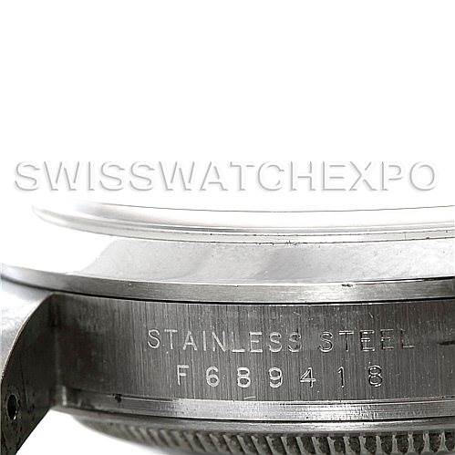 This image shows a close-up of the side of a Rolex Explorer 114270 Men's Stainless Steel Black Dial 114270 Men's Stainless Steel Black Dial stainless steel case with visible serial number engraving.
