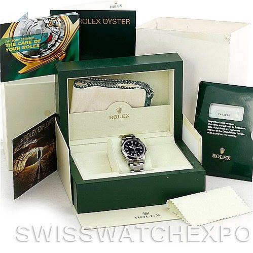 The image shows a Rolex Explorer 114270 Men's Stainless Steel Black Dial 114270 Men's Stainless Steel Black Dial model watch in its box, accompanied by various booklets and tags.