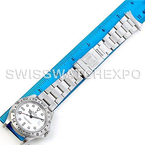 This image shows a top view of a Rolex Explorer 16570 Men's Stainless Steel White Dial 16570 Men's Stainless Steel White Dial model watch, displaying its full stainless steel bracelet next to a ruler for size reference.