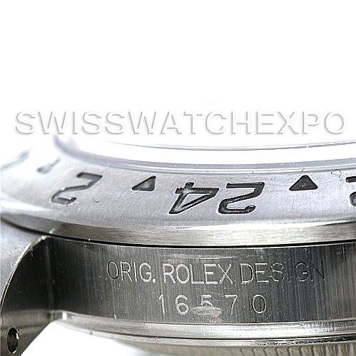 The image shows a close-up of the bezel and case side of a Rolex Explorer 16570 Men's Stainless Steel White Dial 16570 Men's Stainless Steel White Dial model 16570 with engraved text.