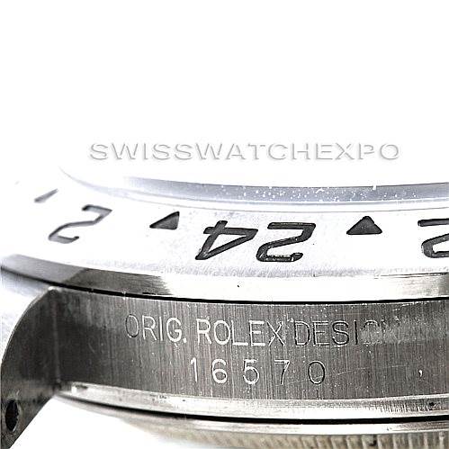 This close-up image of a Rolex Explorer 16570 Men's Stainless Steel White Dial 16570 Men's Stainless Steel White Dial watch shows part of the bezel and case with model number 16570 engraved.