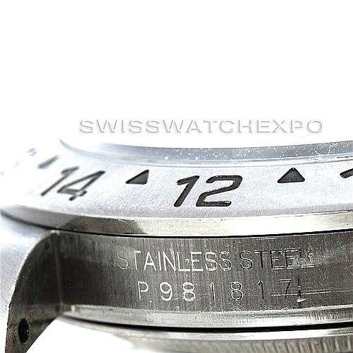 The image shows a close-up side view of a Rolex Explorer 16570 Men's Stainless Steel White Dial 16570 Men's Stainless Steel White Dial model, highlighting the stainless steel case and bezel with engraved numbers.