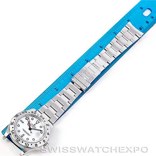 The image shows a Rolex Explorer 16570 Men's Stainless Steel White Dial 16570 Men's Stainless Steel White Dial watch laid flat against a ruler, displaying the entire bracelet and watch face from an overhead angle.