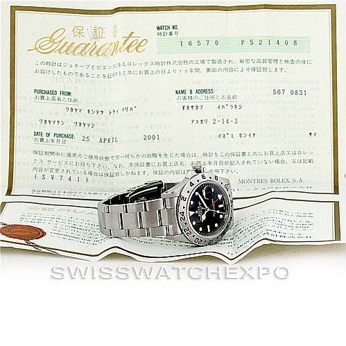 The image shows a Rolex Explorer 16570 Men's Stainless Steel Black Dial 16570 Men's Stainless Steel Black Dial watch placed on its opened guarantee certificate, viewed from a front angle.