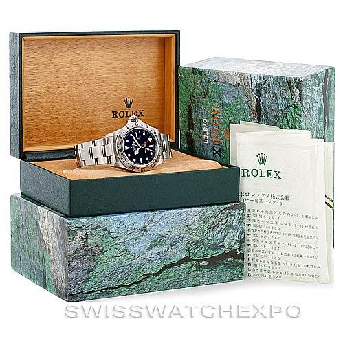 The image shows a Rolex Explorer 16570 Men's Stainless Steel Black Dial 16570 Men's Stainless Steel Black Dial watch in its green and wooden presentation box, accompanied by external packaging and documentation.