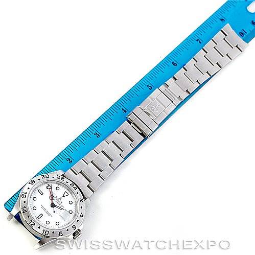 The image shows a Rolex Explorer 16570 Men's Stainless Steel White Dial 16570 Men's Stainless Steel White Dial watch laid flat next to a blue ruler, displaying the face, bezel, and bracelet.