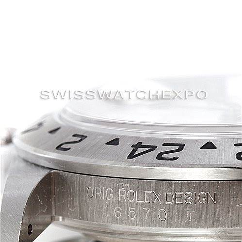 The image shows a close-up of the bezel and case of the Rolex Explorer 16570 Men's Stainless Steel White Dial 16570 Men's Stainless Steel White Dial, highlighting the "ORIG ROLEX DESIGN" engraving and model number 16570T.