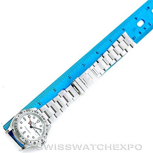 The image shows a Rolex Explorer 16570 Men's Stainless Steel White Dial 16570 Men's Stainless Steel White Dial watch laid flat, with a blue ruler alongside for scale.