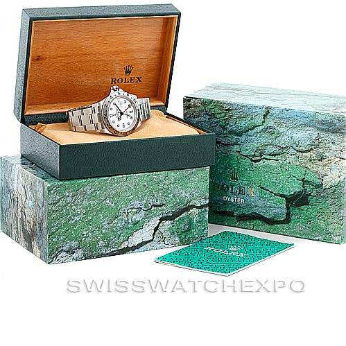 The Rolex Explorer 16570 Men's Stainless Steel White Dial 16570 Men's Stainless Steel White Dial watch is displayed at an angle inside its open box, along with its outer box and booklet shown.