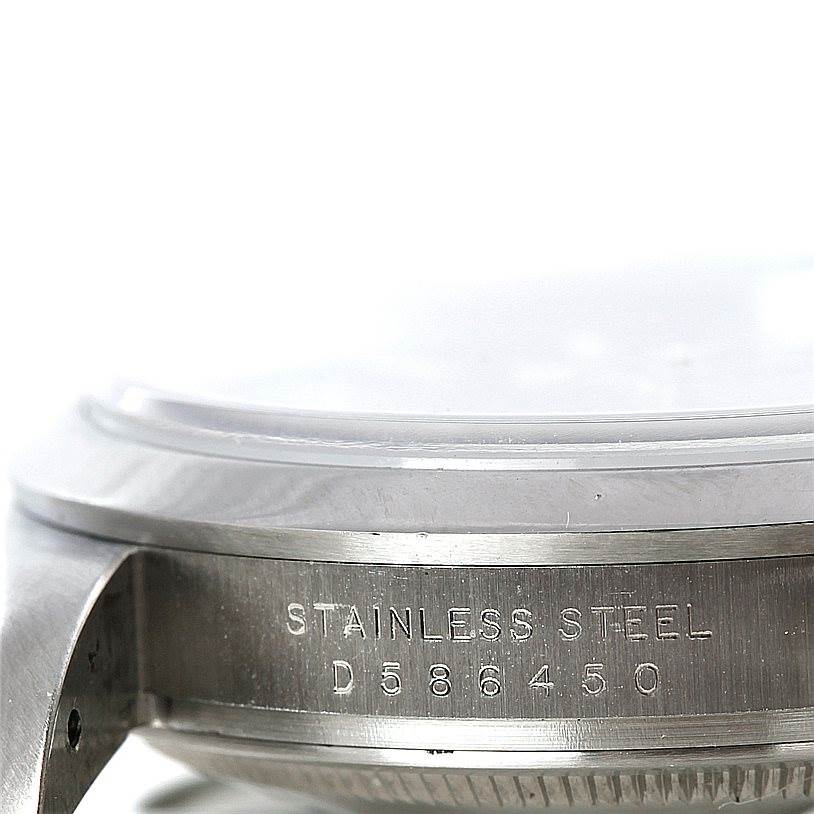 The image shows a close-up side view of the stainless steel case of a Rolex Explorer 114270 Men's Stainless Steel Black Dial 114270 Men's Stainless Steel Black Dial watch displaying its serial number.