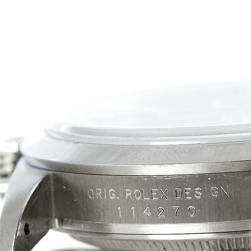This image shows a close-up of the side of a Rolex Explorer 114270 Men's Stainless Steel Black Dial 114270 Men's Stainless Steel Black Dial watch case with the model number engraved.