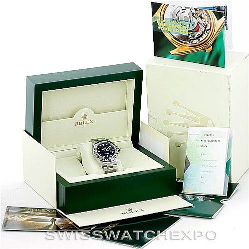 The image shows a Rolex Explorer 16570 Men's Stainless Steel Black Dial 16570 Men's Stainless Steel Black Dial watch and its accessories, including the box, warranty card, and manual, from a slight overhead angle.