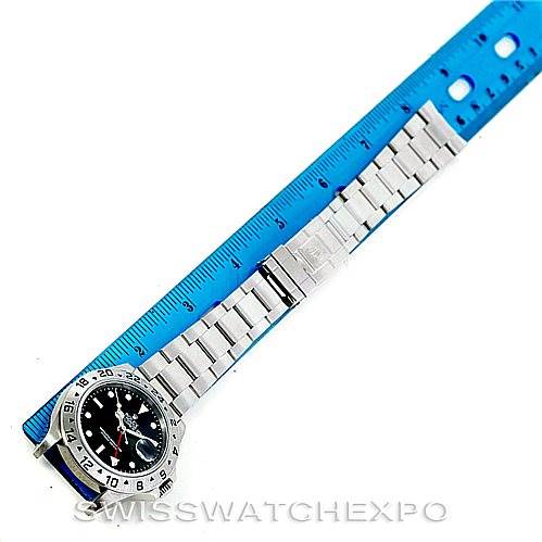 The image shows a full view of a Rolex Explorer 16570 Men's Stainless Steel Black Dial 16570 Men's Stainless Steel Black Dial watch, including the face, bezel, and bracelet, next to a blue ruler.