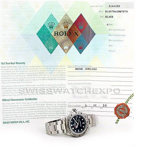The image shows a Rolex Explorer 16570 Men's Stainless Steel Black Dial 16570 Men's Stainless Steel Black Dial model watch laid flat with its warranty card in the background.