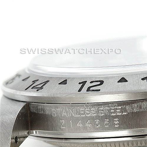 This image shows a close-up side view of a Rolex Explorer 16570 Men's Stainless Steel Black Dial 16570 Men's Stainless Steel Black Dial watch, highlighting the bezel, case, and a portion of the serial number.