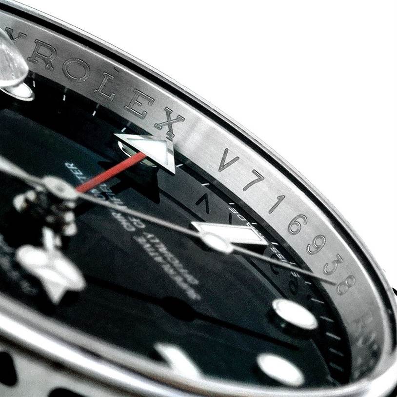 The image shows a close-up of the face and bezel of a Rolex Explorer 16570 Men
s Stainless Steel Black Dial 16570 Men
s Stainless Steel Black Dial watch, highlighting the serial number and brand name.