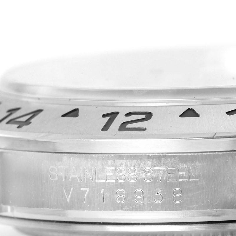This image shows a close-up of the bezel and case edge with the engraving of the Rolex Explorer 16570 Men
s Stainless Steel Black Dial 16570 Men
s Stainless Steel Black Dial model, including the serial number.