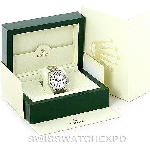 The image shows a Rolex Explorer 216570 Men's Stainless Steel White Dial 216570 Men's Stainless Steel White Dial watch with its box and outer packaging, including the watch's face and part of the bracelet.