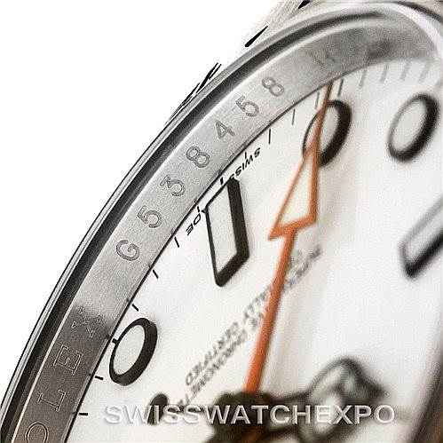This close-up image of the Rolex Explorer 216570 Men's Stainless Steel White Dial 216570 Men's Stainless Steel White Dial watch displays parts of the bezel, dial, and the tip of the orange hand.