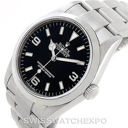 The image shows a close-up, angled view of a Rolex Explorer 114270 Men's Stainless Steel Black Dial 114270 Men's Stainless Steel Black Dial watch, highlighting its black dial, crown, and part of the bracelet.
