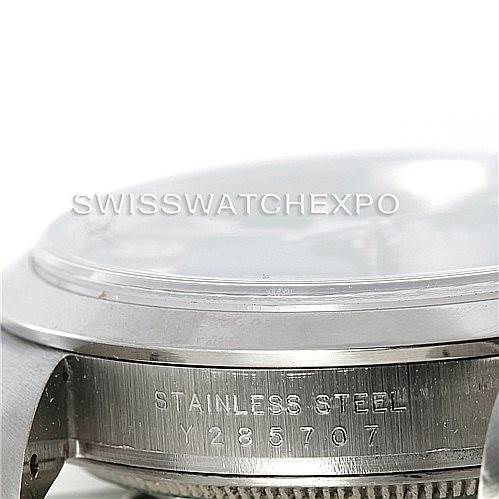 The image shows a close-up side view of a Rolex Explorer 114270 Men's Stainless Steel Black Dial 114270 Men's Stainless Steel Black Dial watch, highlighting the stainless steel case and serial number.