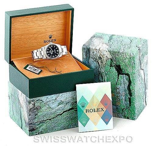 The image shows a Rolex Explorer 114270 Men's Stainless Steel Black Dial 114270 Men's Stainless Steel Black Dial watch at an angled view in its box along with its outer packaging and documentation.