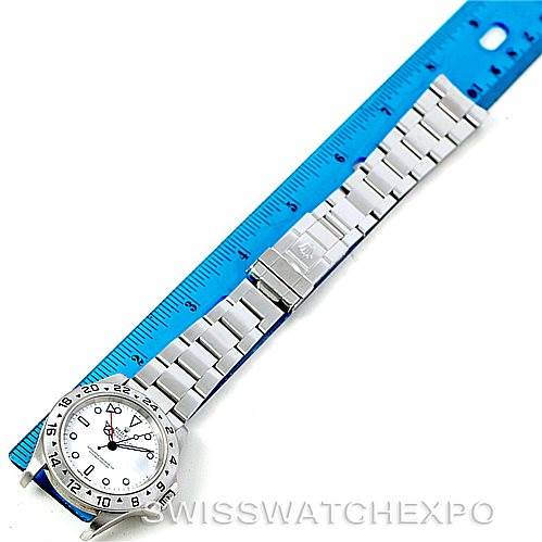 The image shows a top view of a Rolex Explorer 16570 Men
s Stainless Steel White Dial 16570 Men
s Stainless Steel White Dial watch placed alongside a blue ruler.