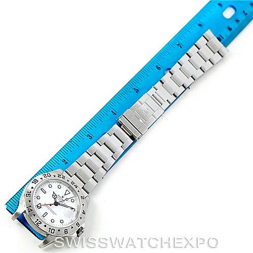 The image shows a top-view angle of a Rolex Explorer 16570 Men's Stainless Steel White Dial 16570 Men's Stainless Steel White Dial watch next to a ruler, highlighting the watch's bracelet and dial.