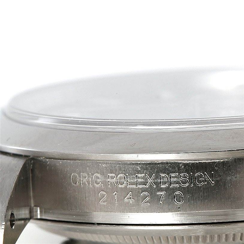 This image shows a close-up angle of the side of a Rolex Explorer 214270 Men's Stainless Steel Black Dial 214270 Men's Stainless Steel Black Dial watch, highlighting the engraved "ORIG. ROLEX DESIGN" and model number.