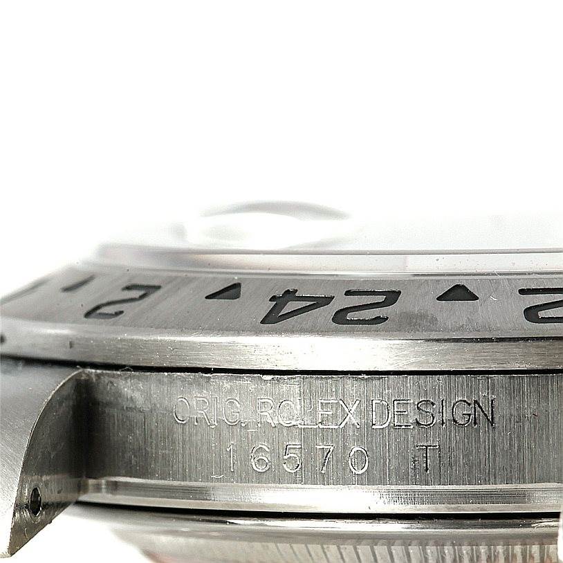 The image shows a close-up side view of the bezel and engraved case markings of a Rolex Explorer 16570 Men's Stainless Steel White Dial 16570 Men's Stainless Steel White Dial model 16570.