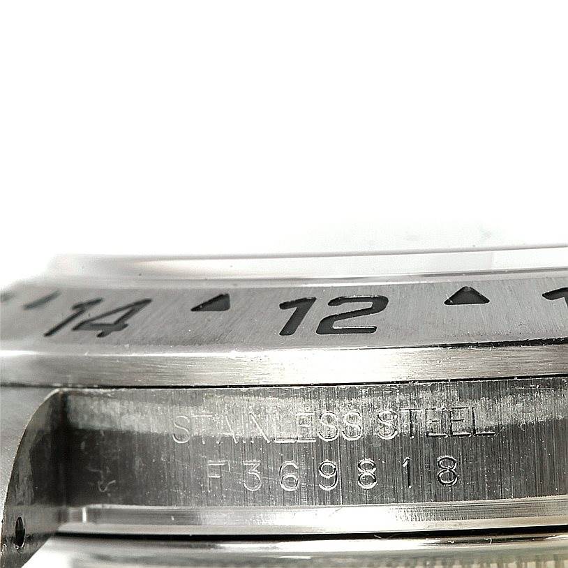 The image shows a close-up side view of the bezel and case of a Rolex Explorer 16570 Men's Stainless Steel White Dial 16570 Men's Stainless Steel White Dial watch, highlighting the stainless steel and the engraved numbers.