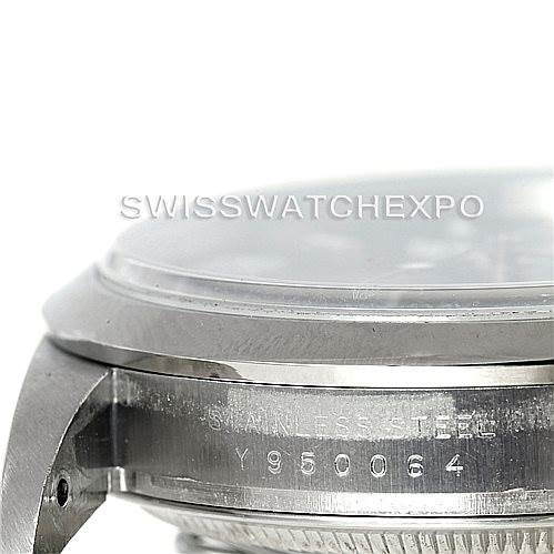 The image shows a close-up side view of the Rolex Explorer 114270 Men's Stainless Steel Black Dial 114270 Men's Stainless Steel Black Dial watch case, highlighting the serial number and "STAINLESS STEEL" engraving.