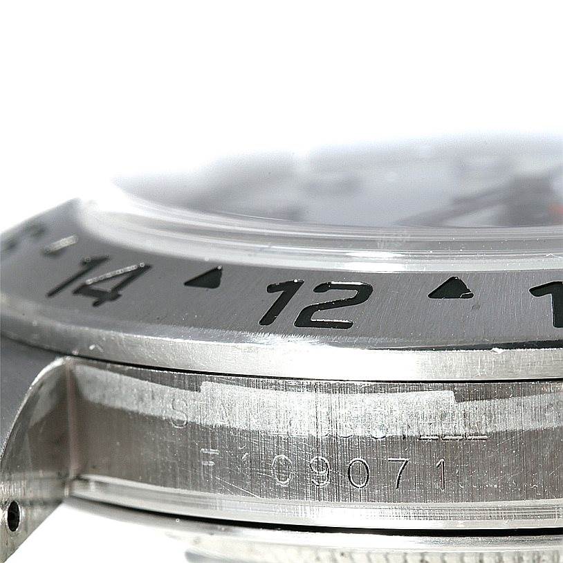 This image shows a close-up side view of the bezel and part of the case of a Rolex Explorer 16570 Men's Stainless Steel White Dial 16570 Men's Stainless Steel White Dial model watch.