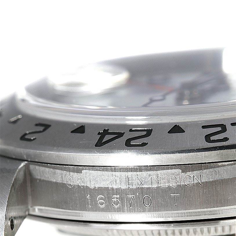 This close-up angle shows the bezel and part of the casing with "Orig Rolex Design" and model number 16570 of the Rolex Explorer 16570 Men's Stainless Steel White Dial 16570 Men's Stainless Steel White Dial watch.