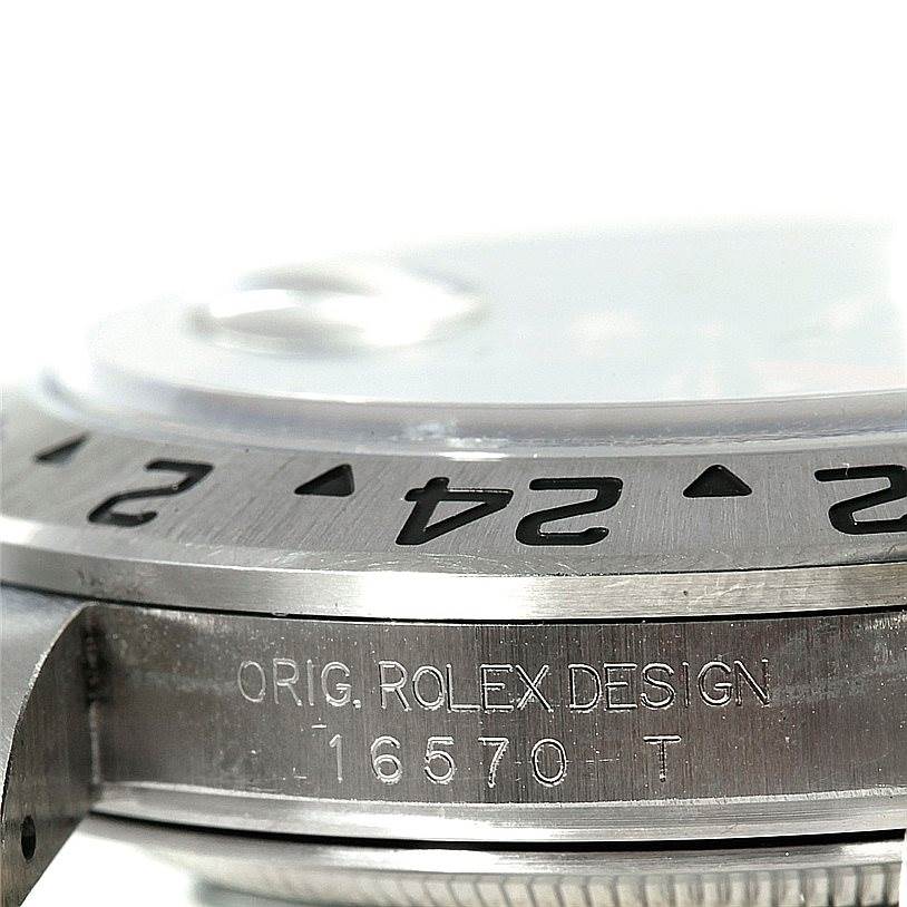 The image shows a close-up side view of the Rolex Explorer 16570 Men's Stainless Steel Black Dial 16570 Men's Stainless Steel Black Dial model, highlighting the bezel and "Orig. Rolex Design 16570-T" engraving.