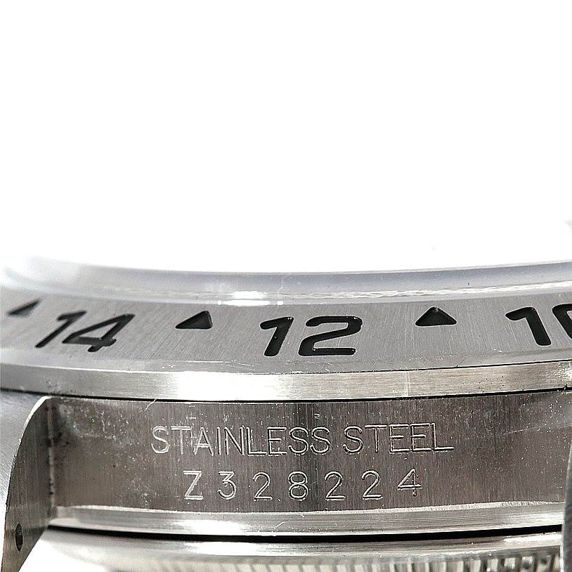 This image shows a close-up of the bezel and case side of a Rolex Explorer 16570 Men's Stainless Steel Black Dial 16570 Men's Stainless Steel Black Dial watch, highlighting the serial number and stainless steel material.