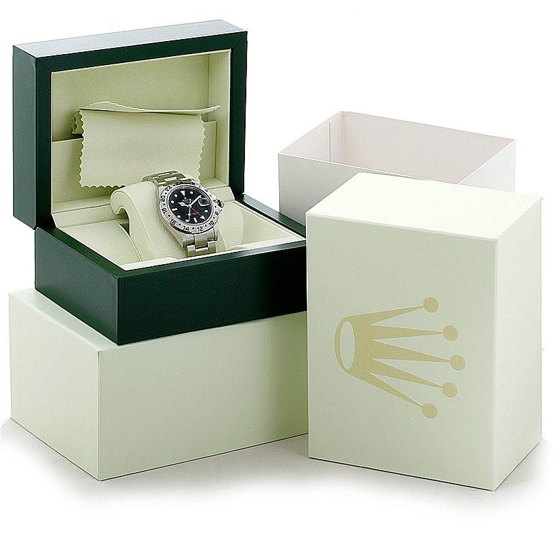 The Rolex Explorer 16570 Men's Stainless Steel Black Dial 16570 Men's Stainless Steel Black Dial watch is shown at a front angle, in its open box set with packaging boxes in the background.