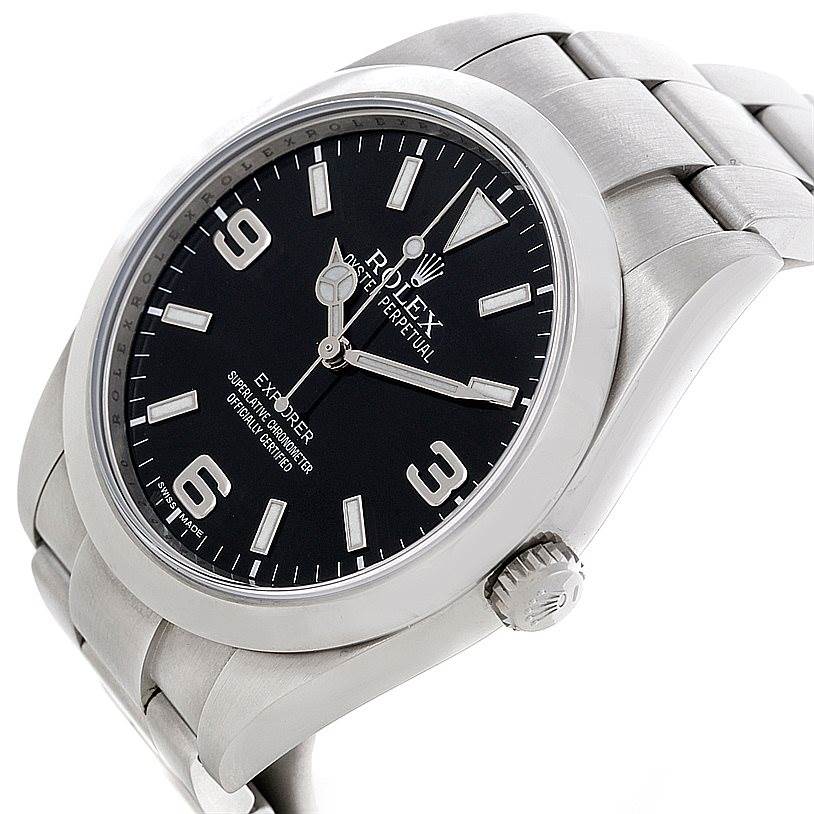 The image shows a close-up angled view of the Rolex Explorer 214270 Men's Stainless Steel Black Dial 214270 Men's Stainless Steel Black Dial watch face, bezel, crown, and part of the bracelet.