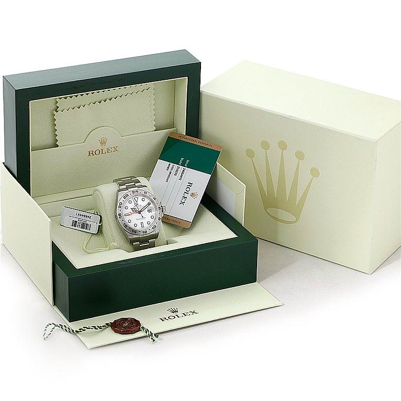 The Rolex Explorer 216570 Men's Stainless Steel White Dial 216570 Men's Stainless Steel White Dial watch is shown in its open box with tags, manuals, and accessories visible.
