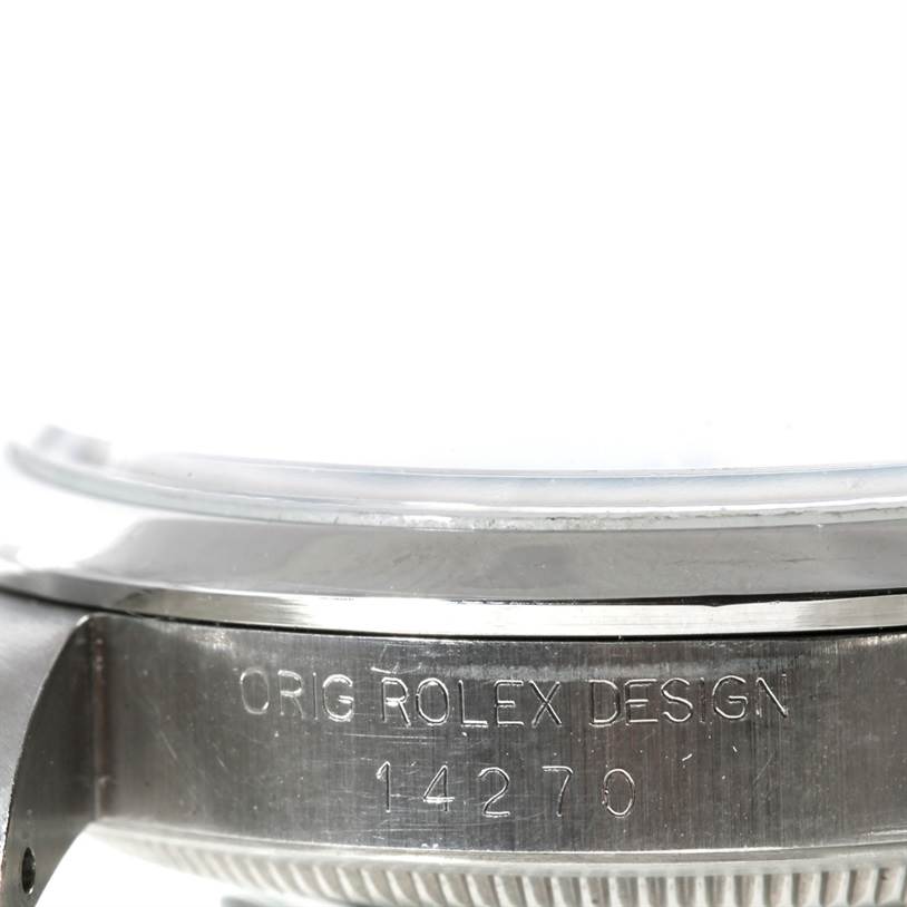 This image shows a close-up of the side of the Rolex Explorer 14270 Men's Stainless Steel Black Dial 14270 Men's Stainless Steel Black Dial watch, displaying its model number "14270" and "Orig Rolex Design" engraving.