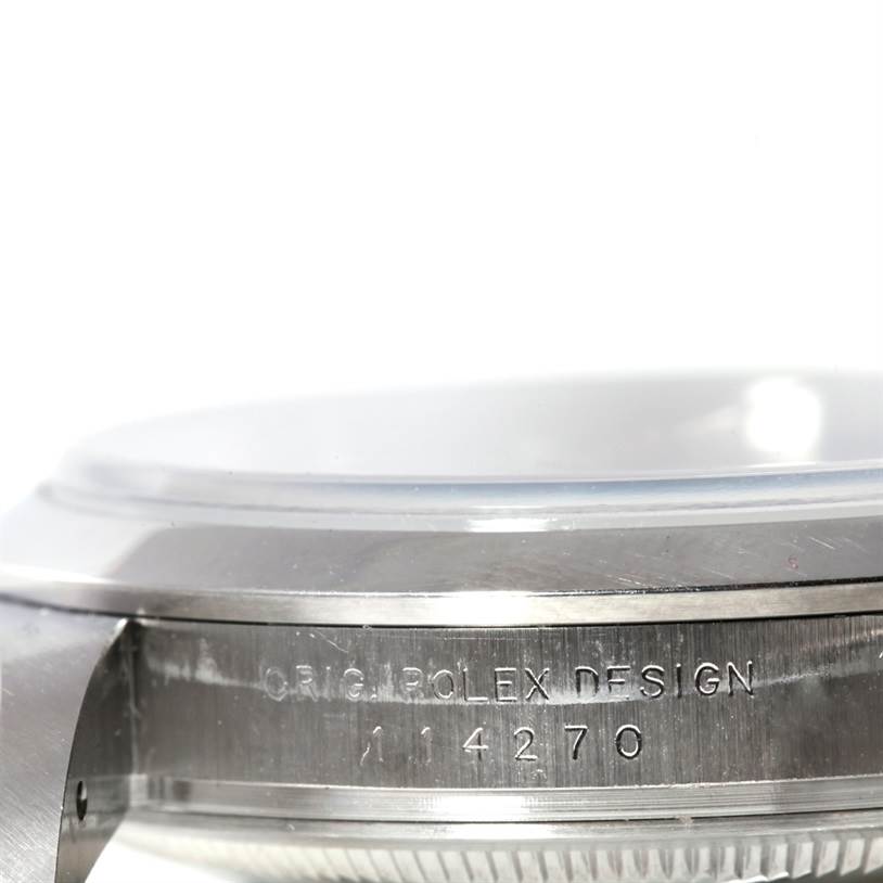 This image shows a side view of the case of a Rolex Explorer 114270 Men's Stainless Steel Black Dial 114270 Men's Stainless Steel Black Dial watch, specifically focusing on the engraved model number.