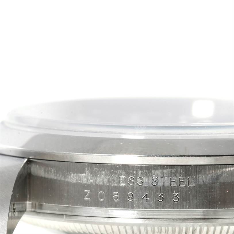 The image shows a close-up side view of the Rolex Explorer 114270 Men's Stainless Steel Black Dial 114270 Men's Stainless Steel Black Dial watch, highlighting its stainless steel case and serial number.