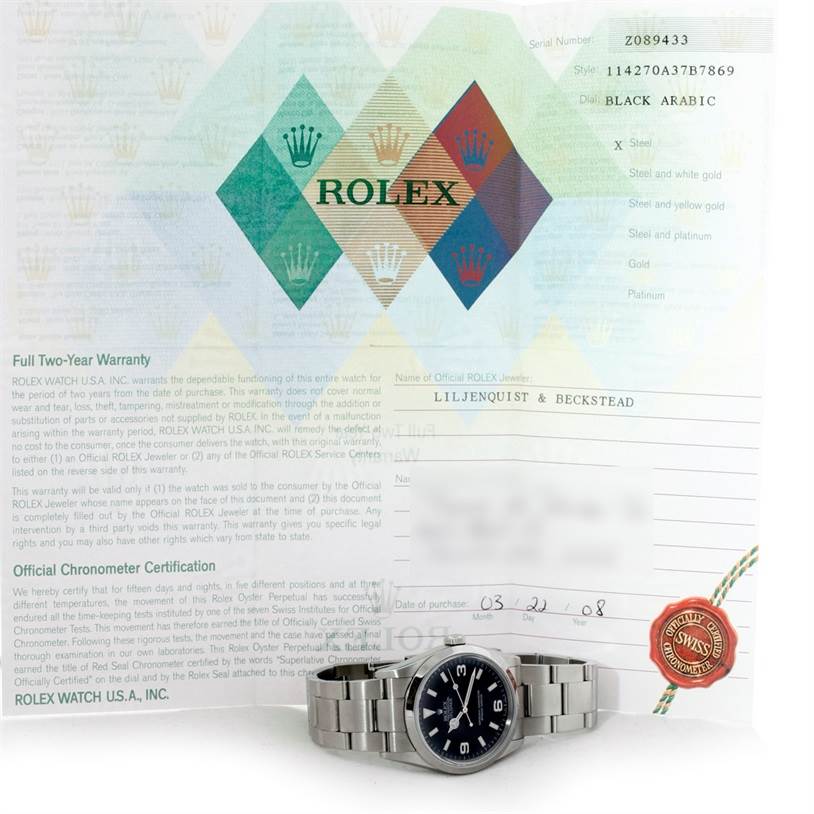 The image shows a front angle of the Rolex Explorer 114270 Men's Stainless Steel Black Dial 114270 Men's Stainless Steel Black Dial watch along with its warranty certificate and official documentation.