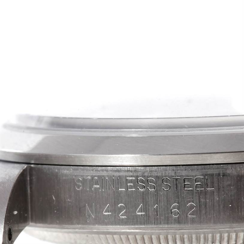 This image shows a close-up side view of the stainless steel casing of a Rolex Explorer 14270 Men's Stainless Steel Black Dial 14270 Men's Stainless Steel Black Dial watch, highlighting the engraved serial number.