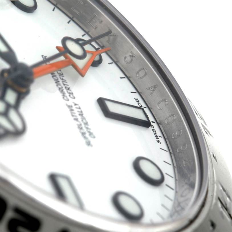This close-up angle shows the face, orange hand, and part of the bezel of the Rolex Explorer 216570 Men's Stainless Steel White Dial 216570 Men's Stainless Steel White Dial watch.