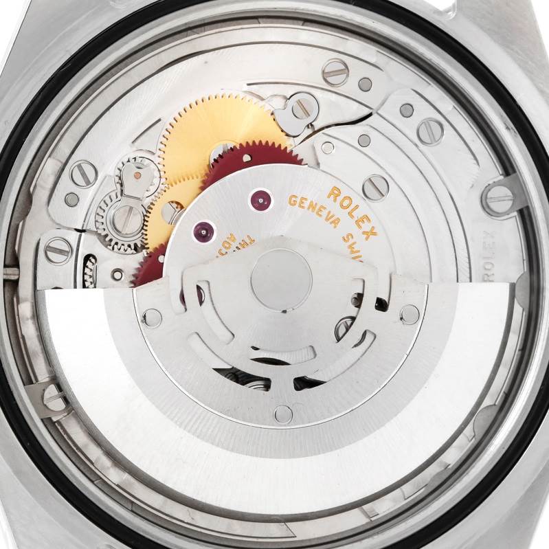 The image shows the movement mechanism of the Rolex Explorer 214270 Men's Stainless Steel Black Dial 214270 Men's Stainless Steel Black Dial watch, providing a rear view of its intricate gears and components.