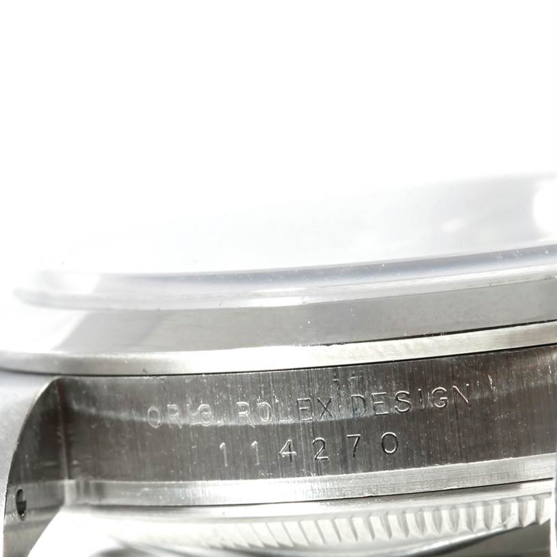 The image shows a close-up view of the side of the Rolex Explorer 114270 Men's Stainless Steel Black Dial 114270 Men's Stainless Steel Black Dial watch, highlighting the case and engraved serial number.