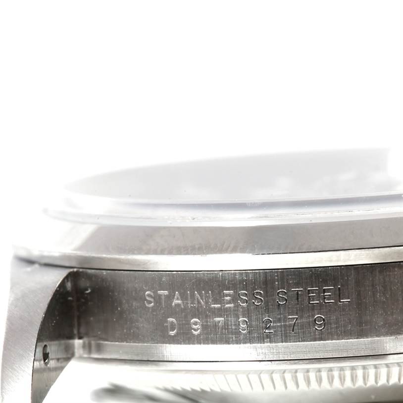 The image shows a close-up side view of a Rolex Explorer 114270 Men's Stainless Steel Black Dial 114270 Men's Stainless Steel Black Dial model, focusing on the stainless steel case with part of the serial number visible.