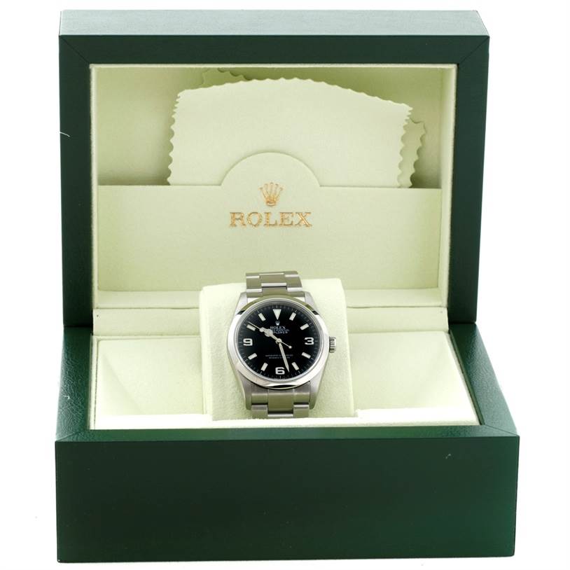 The Rolex Explorer 114270 Men's Stainless Steel Black Dial 114270 Men's Stainless Steel Black Dial watch is photographed from the front in an open green box, displaying its dial, case, and bracelet.